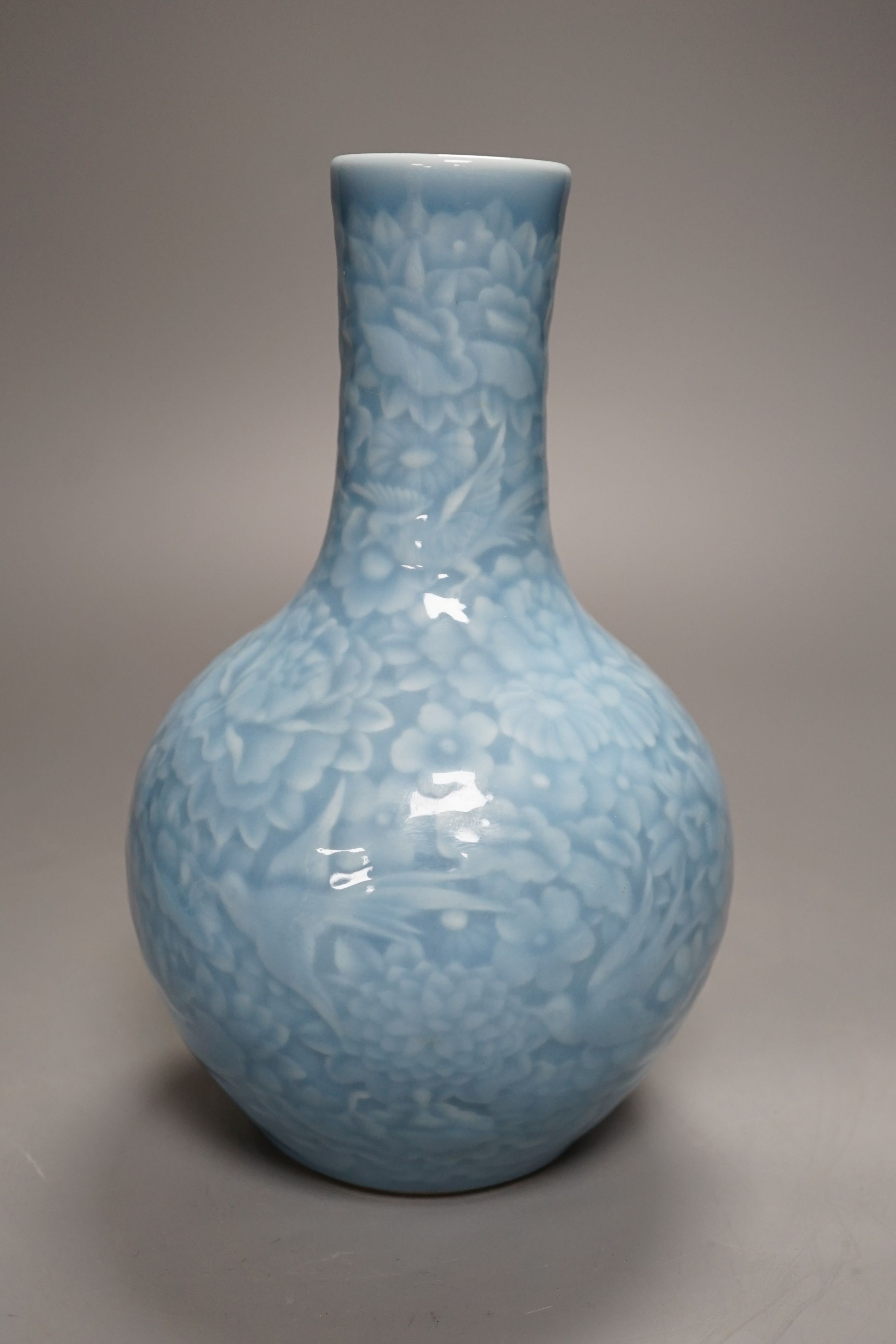 A Chinese blue-glazed moulded bottle vase - 23cm high